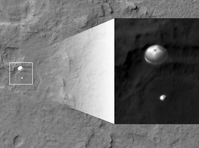 An image taken by the High Resolution Imaging Science Experiment (HiRISE) camera aboard NASA's Mars Reconnaissance orbiter, capturing the Curiosity rover still connected to its 51-foot-wide (almost 16 meter) parachute as it descended towards its landing site at Gale Crater on August 5, 2012 is seen in this handout picture released by NASA on August 6, 2012.