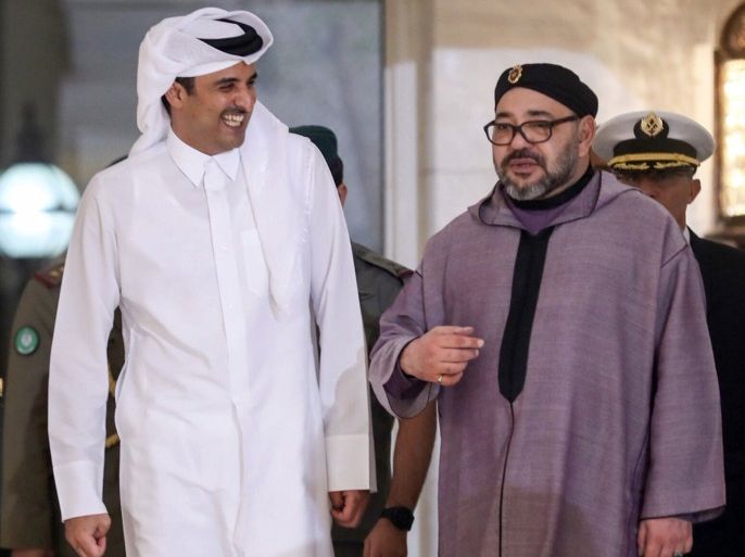King of Morocco Mohammed VI (R) is welcomed by Emir of Qatar Sheikh Tamim bin Hamad Al Thani