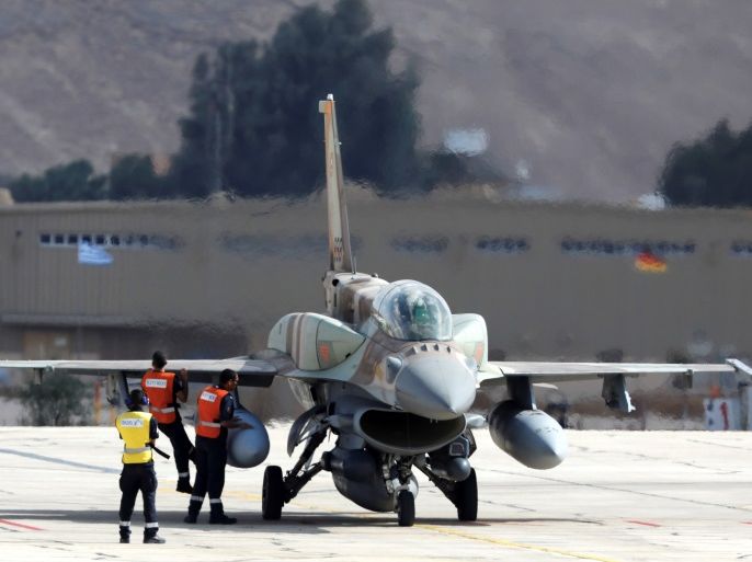 Crew members check an Israeli F16 fighter jet before it takes off during a joint international aerial training exercise hosted by Israel and dubbed