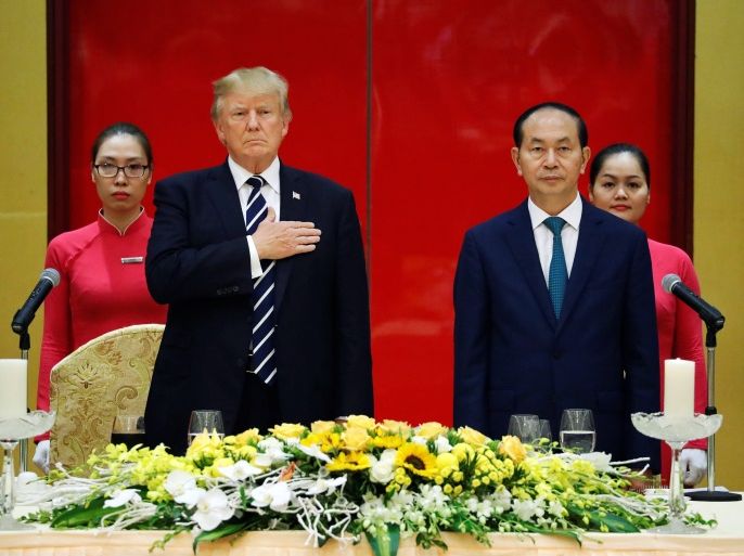 U.S. President Donald Trump and Vietnam's President Tran Dai Quang (2nd R) stand for the U.S. national anthem at the top of a state banquet in Trump's honor at the International Convention Center in Hanoi, Vietnam November 11, 2017. REUTERS/Jonathan Ernst