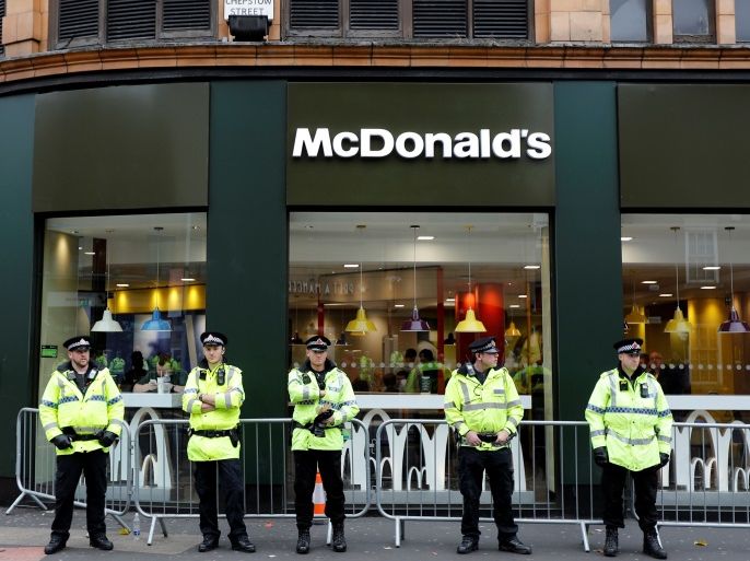 Police Officers stand guard outside a McDonalds restaurant during a protest on the opening day of the Conservative Party Conference in Manchester, Britain October 1, 2017. REUTERS/Darren Staples