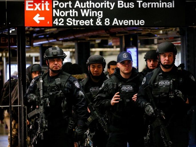 Members of the Port Authority Police Counter Terrorism unit patrol the subway corridor, at the New York Port Authority subway station near the site of an attempted detonation the day before, during the morning rush in New York City, U.S. December 12, 2017. REUTERS/Brendan McDermid