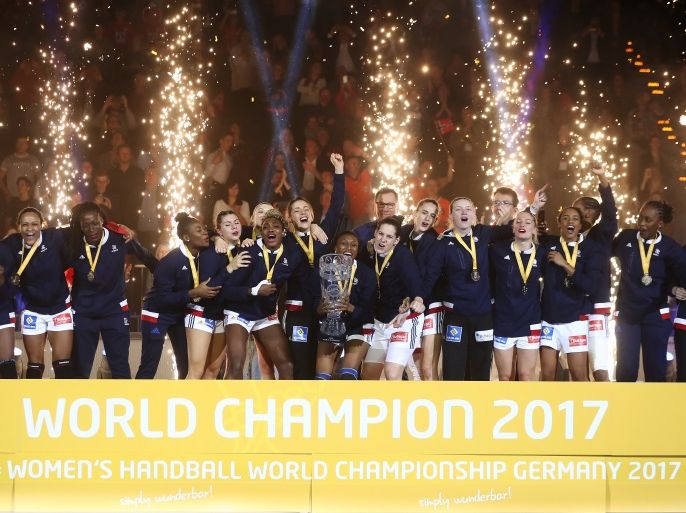 HAMBURG, GERMANY - DECEMBER 17: Team of France celebrate with the trophy after the IHF Women's Handball World Championship final match between France and Norway at Barclaycard Arena on December 17, 2017 in Hamburg, Germany. (Photo by Oliver Hardt/Bongarts/Getty Images)
