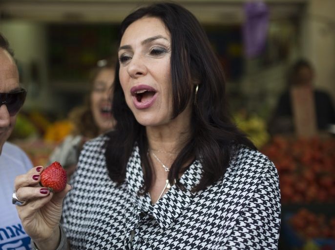 Likud legislator Miri Regev, a former brigadier general and political hardliner of Moroccan origin, eats a strawberry during a campaign stop at a market in Netanya, north of Tel Aviv February 25, 2015. Israel's Sephardic community, Jews of Middle Eastern descent, have traditionally been the Likud party's backbone. But political analysts say Sephardim, disproportionately poorer than Israel's Ashkenazi Jews with roots in Europe, may throw their support elsewhere in the