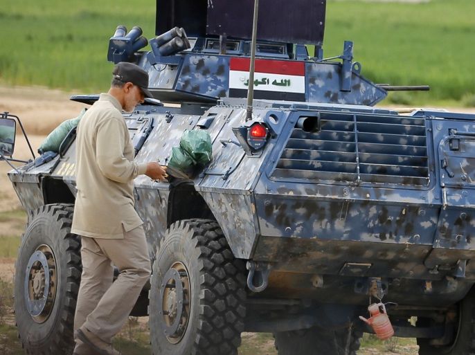 Iranian Revolutionary Guard Commander Qassem Soleimani walks near an armoured vehicle at the frontline during offensive operations against Islamic State militants in the town of Tal Ksaiba in Salahuddin province March 8, 2015. Picture taken March 8, 2015. REUTERS/Stringer (IRAQ - Tags: CIVIL UNREST CONFLICT POLITICS)