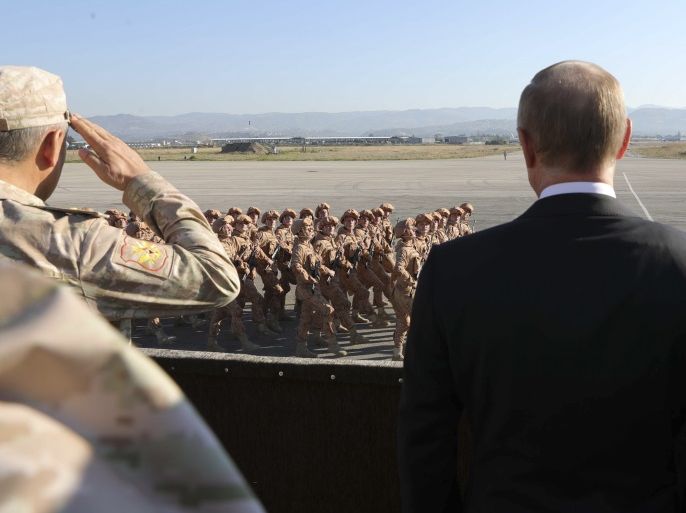 Russian President Vladimir Putin (R) and Defence Minister Sergei Shoigu watch servicemen passing by as they visit the Hmeymim air base in Latakia Province, Syria December 11, 2017. Sputnik/Mikhail Klimentyev/Sputnik via REUTERS ATTENTION EDITORS - THIS IMAGE WAS PROVIDED BY A THIRD PARTY.