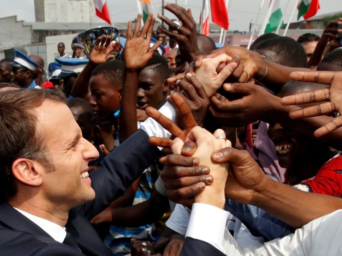 French President Emmanuel Macron greets people in the crowd as he leaves a ceremony to start the construction of the first metro line in Abidjan, Ivory Coast, November 30, 2017. REUTERS/Philippe Wojazer