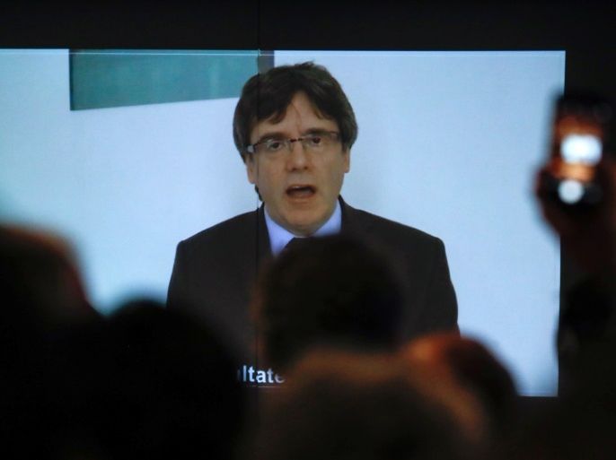 Former Catalan President Carles Puigdemont appears on a screen as he delivers a speech during the new year's party of Leuven city local section of Belgium's nationalist party NV-A, in Leuven, Belgium, January 30, 2018. REUTERS/Yves Herman