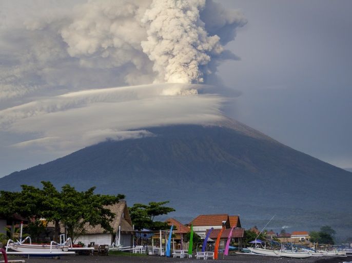 KARANGASEM, BALI, INDONESIA - NOVEMBER 28: General view of Mount Agung during an eruption while spewing volcanic ash into the sky on November on November 28, 2017 in Karangasem, Island of Bali, Indonesia. Indonesian authorities raised the state of alert to its highest level for the volcano, Mount Agung, after thick ash started shooting thousands of meters into the air with increasing intensity. Based on reports, as many as 100,000 villagers will need to leave the expand