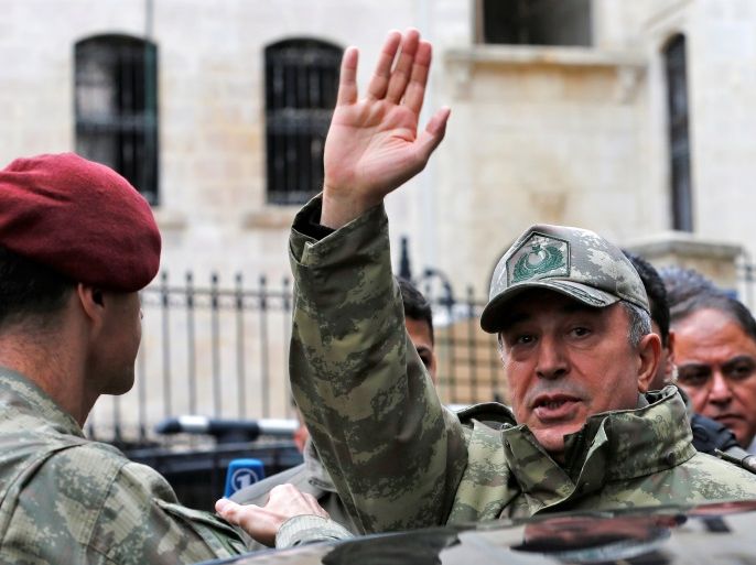 Turkey's Chief of the General Staff Hulusi Akar greets residents as he visits a neighborhood after a building was hit by rockets fired from Syria's Afrin region, in the border town of Kilis, Turkey, January 27, 2018. REUTERS/Murad Sezer