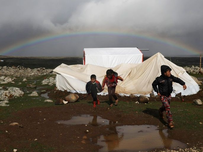 A rainbow is seen over Quneitra as internally displaced children run at a refugee camp in Quneitra, Syria, January 19, 2018. REUTERS/Alaa Al-Faqir TPX IMAGES OF THE DAY صورة للالبوم