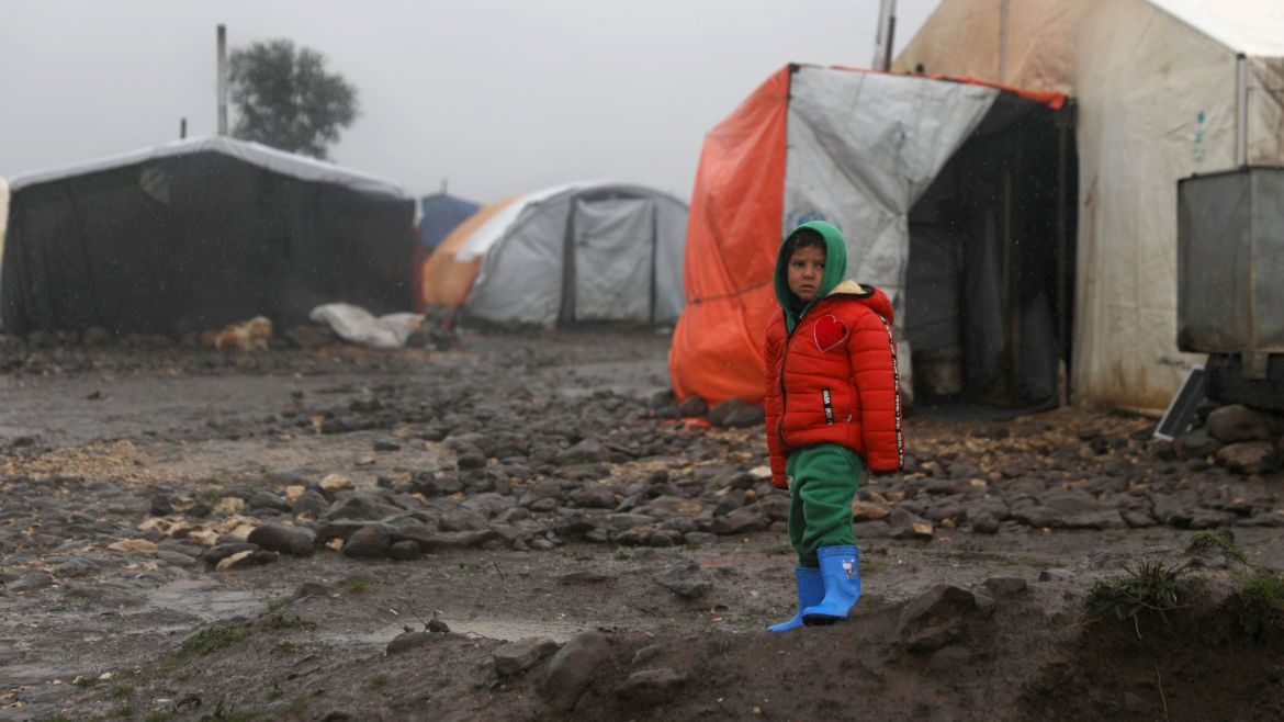 An internally displaced child stands near tents at a refugee camp in Quneitra, Syria, January 19, 2018. REUTERS/Alaa Al-Faqir