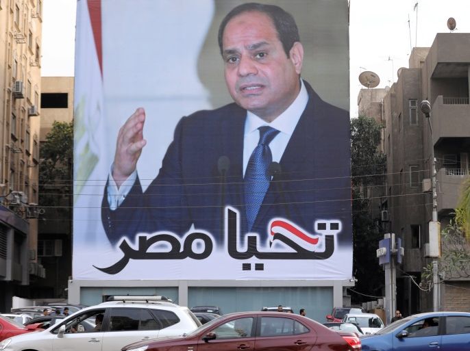 Cars pass by a poster of Egypt's President Abdel Fattah al-Sisi for the upcoming presidential election, in Cairo, Egypt, February 19, 2018. The writing on the poster reads: