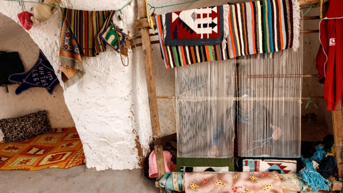 Mounjia, 60, weaves carpet at her troglodyte home in Matmata, Tunisia, February 6, 2018.