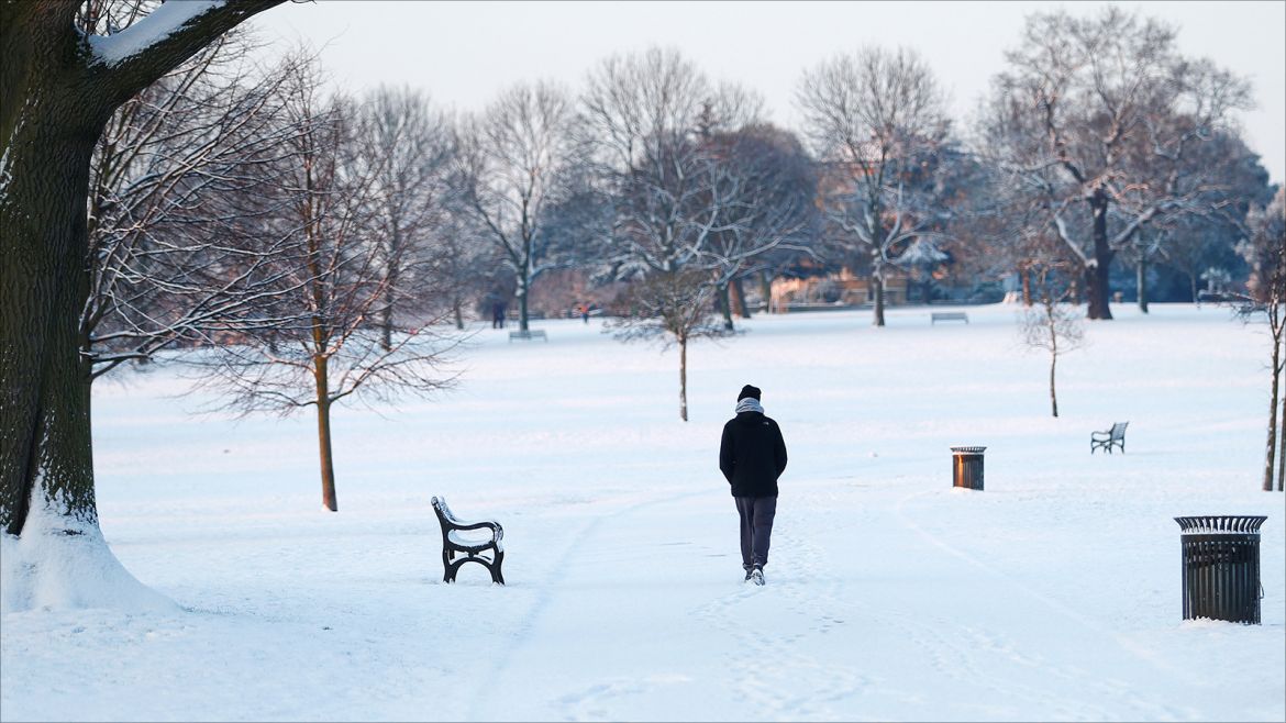 A man walks in a snow covered park in south London, Britain February 28, 2018. REUTERS/Andrew Winning