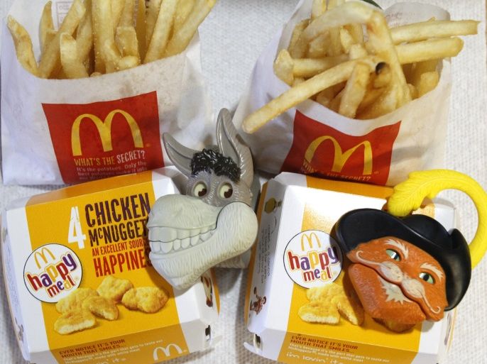 Two McDonald's Happy Meal with toy watches fashioned after the characters Donkey and Puss in Boots from the movie