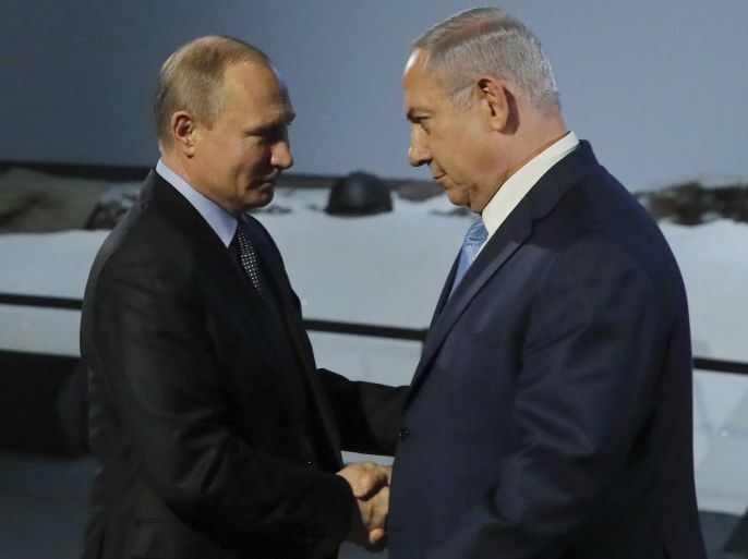 Russian President Vladimir Putin and Israeli Prime Minister Benjamin Netanyahu shake hands as they attend an event marking the International Holocaust Victims Remembrance Day and the 75th anniversary of the breakthrough the Nazi Siege of Leningrad in the World War II, at the Jewish Museum and Tolerance Centre in Moscow, Russia January 29, 2018. REUTERS/Maxim Shemetov