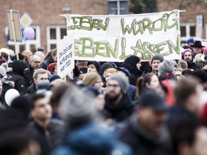 BERLIN, GERMANY - FEBRUARY 03: Refugees and supportive locals march under the motto 'Live Without Hate' in the city center to protest for peaceful co-existence on February 3, 2018 in Cottbus, Germany. Around 15000 people attend this march. State authorities recently halted sending newly-arrived refugees to Cottbus following heightened tensions in the city. In one incident a Syrian teenager was recently arrested for attacking a German couple with a knife. In another skinheads forced there way into an apartment building shared by Germans and refugees and beat three Afghan residents. Cottbus has a strong neo-Nazi scene and a local social worker says incidences of neo-Nazis harassing refugees have been recurrent ever since 2015, when refugees began settling in Cottbus following the wave of over a million refugees and migrants who came to Germany. (Photo by Carsten Koall/Getty Images)