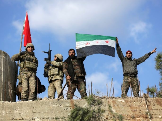 Turkish forces and Free Syrian Army members hold flags on Mount Barsaya, northeast of Afrin, Syria January 28, 2018. REUTERS/ Khalil Ashawi