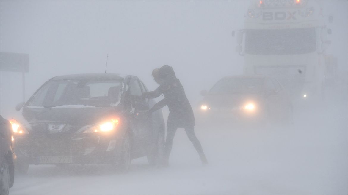 A woman seeks shelter from the blizzard in her stranded car near Sjobo, Sweden, February 27, 2018. TT News Agency/Johan Nilsson/via REUTERS ATTENTION EDITORS - THIS IMAGE WAS PROVIDED BY A THIRD PARTY. SWEDEN OUT. NO COMMERCIAL OR EDITORIAL SALES IN SWEDEN?