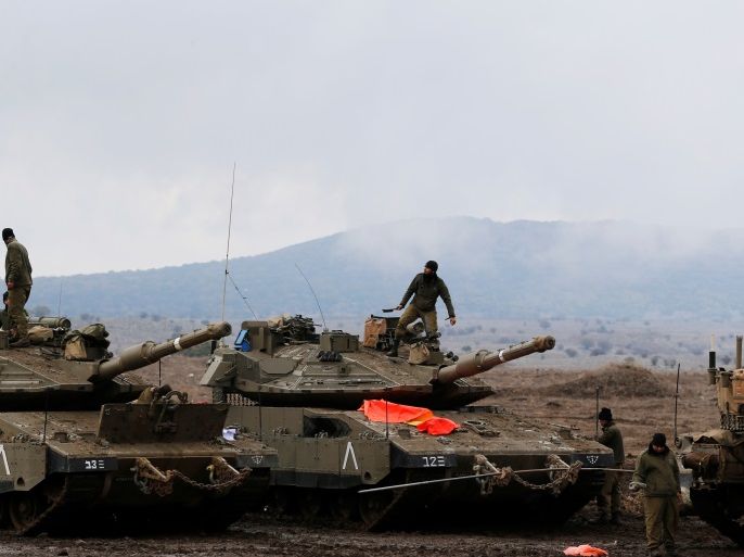 Israeli soldiers stand atop tanks in the Israeli-occupied Golan Heights, close to Israel's frontier with Syria November 22, 2017. REUTERS/Ammar Awad