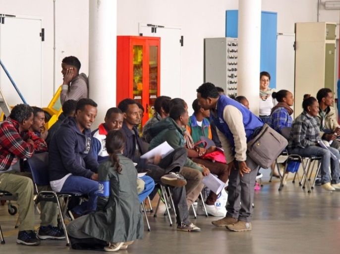 epa04970262 Eritrean refugees wait in a hanger to depart to Sweden aboard an Italian aircraft, at Rome's Ciampino airport, near Rome, Italy, 09 October 2015. Nineteen Eritreans - five women and 14 men - were flown from Italy to Sweden on 09 October, marking the start of an EU scheme for the redistribution of an overall 160,000 asylum seekers across the bloc. EPA/TELENEWS
