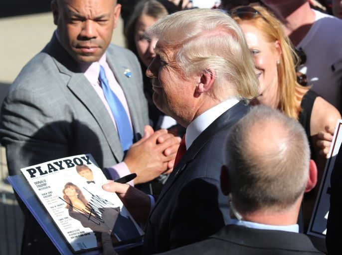 U.S. Republican presidential candidate Donald Trump holds a copy of Playboy Magazine he signed at his campaign rally at Werner Enterprises Hangar in Omaha, Nebraska, US May 6, 2016. REUTERS/Lane Hickenbottom