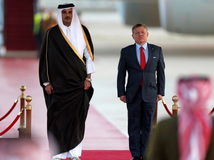 Jordan's King Abdullah stands next to Qatari Emir Sheikh Tamim bin Hamad al-Thani during a reception ceremony at the Queen Alia International Airport in Amman, Jordan March 28, 2017. REUTERS/Muhammad Hamed