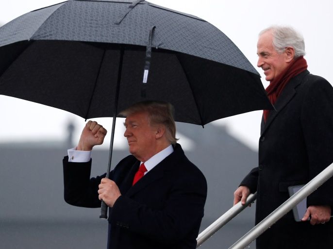 U.S. President Donald Trump, walking ahead of U.S. Senator Bob Corker (R-TN) en route to deliver remarks at the American Farm Bureau Federation convention, arrives aboard Air Force One at Nashville International Airport in Nashville, Tennessee, U.S. January 8, 2018. REUTERS/Jonathan Ernst