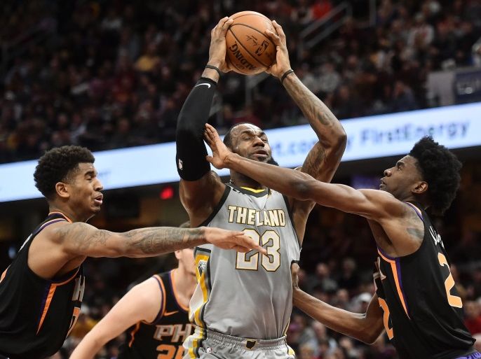 Mar 23, 2018; Cleveland, OH, USA; Cleveland Cavaliers forward LeBron James (23) drives to the basket between Phoenix Suns forward Marquese Chriss (0) and guard Josh Jackson (20) during the first half at Quicken Loans Arena. Mandatory Credit: Ken Blaze-USA TODAY Sports