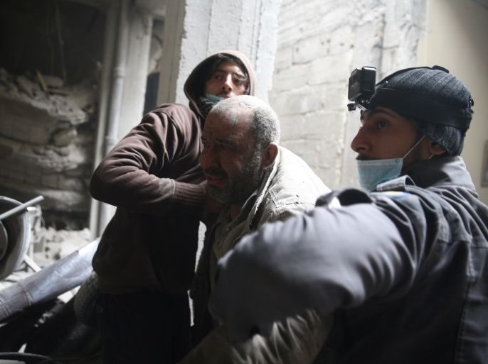 Abu Mohammad Alaya, 50, is helped out from shelter in Douma, Syria February 22, 2018. Picture taken February 22, 2018. REUTERS/Bassam Khabieh