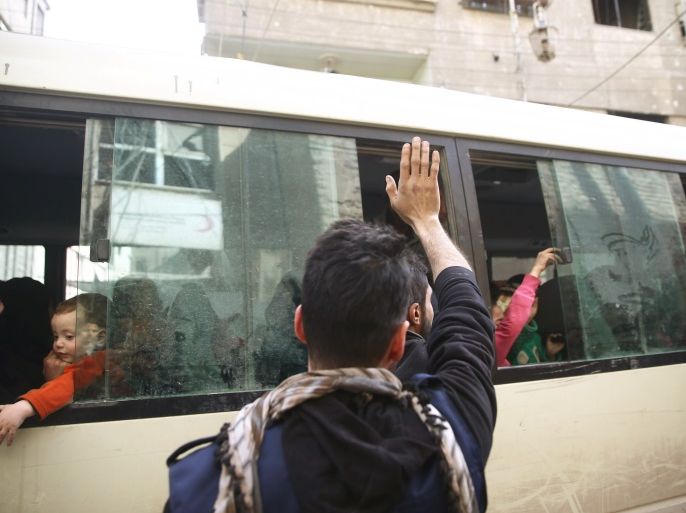 A man gestures as people are evacuated in the besieged town of Douma, Eastern Ghouta, in Damascus, Syria March 19, 2018. REUTERS/Bassam Khabieh