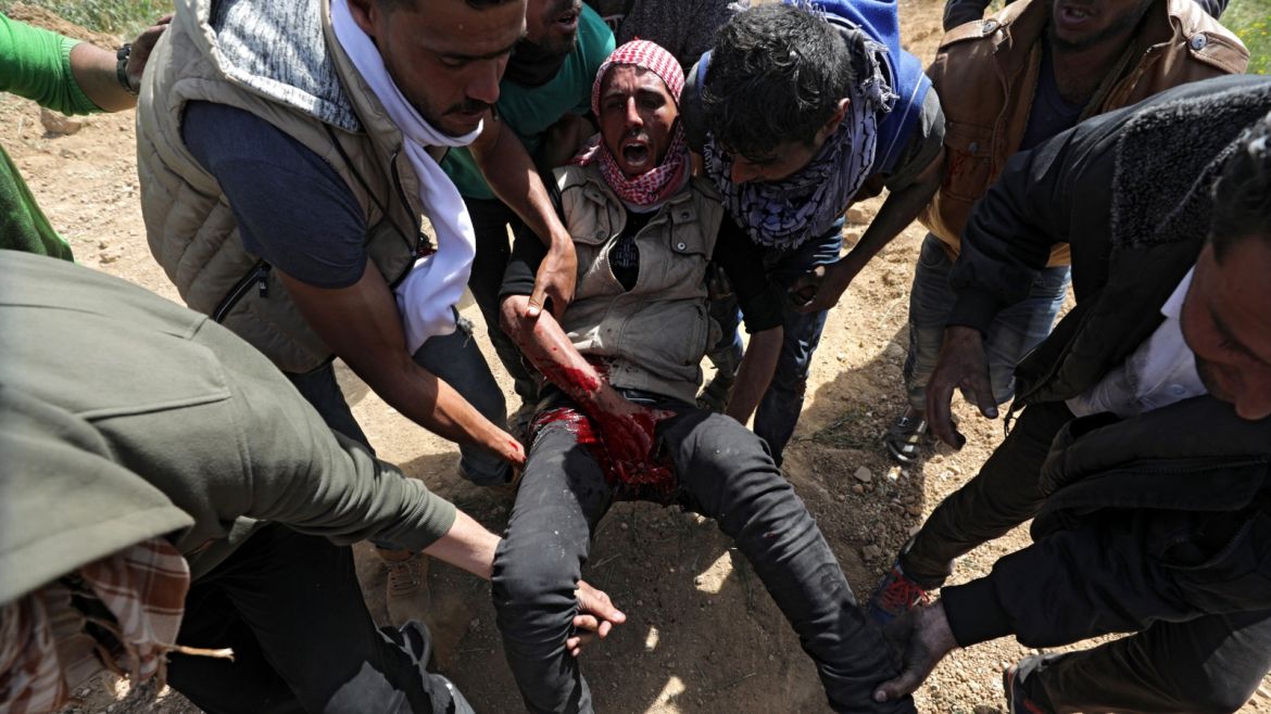 epa06650393 Palestinians protesters carry a wounded youth during clashes with Israeli troops, near the border with Israel in the east of Gaza City, 06 April 2018. Islamist Hamas group that rules the coastal enclave called for another protest on 06 April near the border with Israel, a week after 18 Palestinians were killed in clashes with Israeli forces during a march toward the border with the Israeli territory to commemorate their Land Day on 30 March. Protesters plan to call for the right of Palestinian refugees across the Middle East to return to homes they fled in the war surrounding the 1948 creation of Israel. EPA-EFE/MOHAMMED SABER