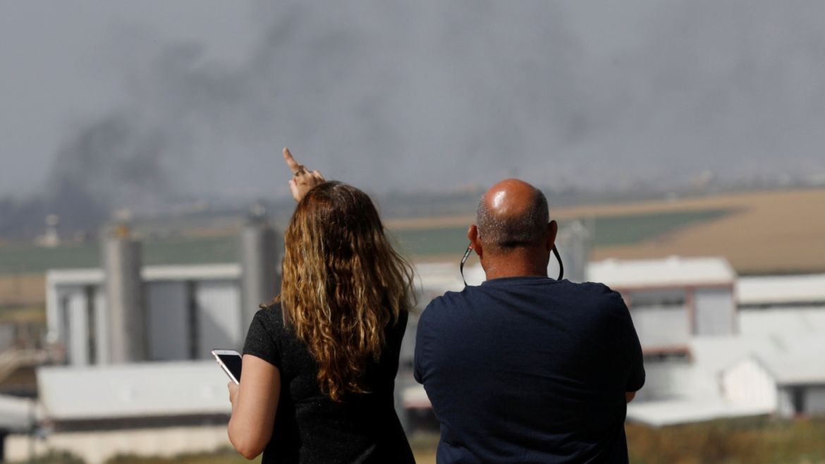 Israelis look at the Israel-Gaza border line as Palestinian protestors clash with Israeli soldiers April 6, 2018. REUTERS/Amir Cohen