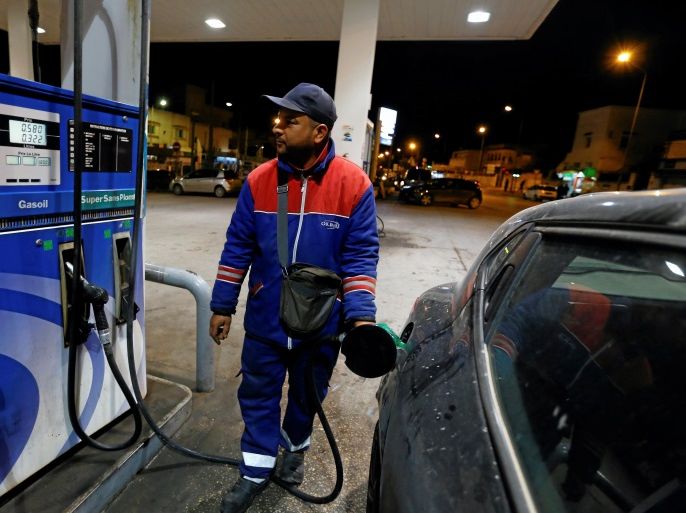 A gas station attendant pumps fuel into a customer's car at a gas station in Tunis, Tunisia March 31, 2018. REUTERS/Zoubeir Souissi