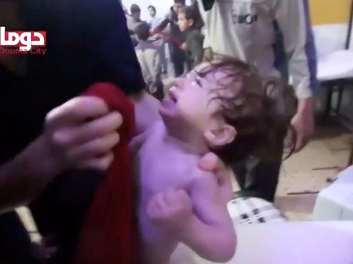 A child cries as they have their face wiped following alleged chemical weapons attack, in what is said to be Douma, Syria in this still image from video obtained by Reuters on April 8, 2018. White Helmets/Reuters TV via REUTERS THIS IMAGE HAS BEEN SUPPLIED BY A THIRD PARTY.