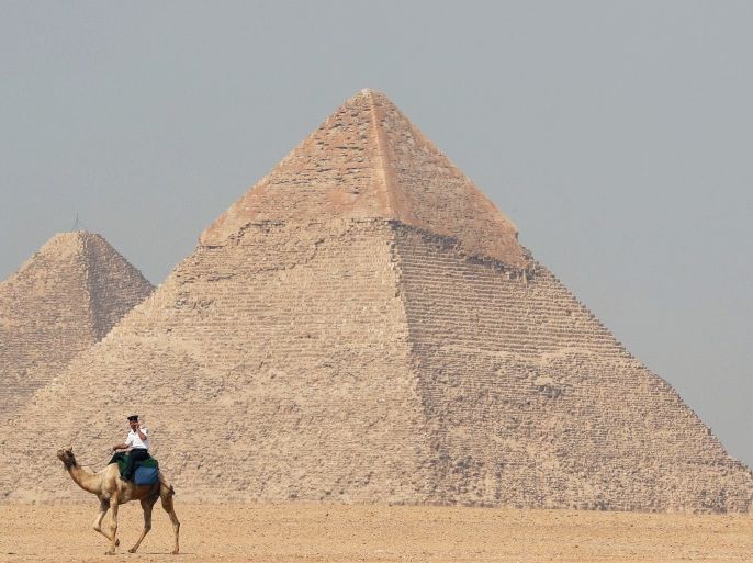 A police officer patrols the Giza Pyramids on his camel on the outskirts of Cairo, Egypt April 28, 2018. REUTERS/Mohamed Abd El Ghany