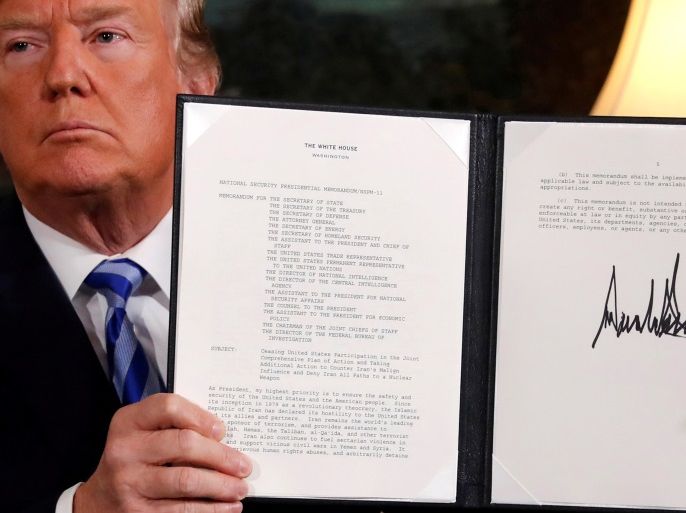U.S. President Donald Trump holds up a proclamation declaring his intention to withdraw from the JCPOA Iran nuclear agreement after signing it in the Diplomatic Room at the White House in Washington, U.S. May 8, 2018. REUTERS/Jonathan Ernst TPX IMAGES OF THE DAY