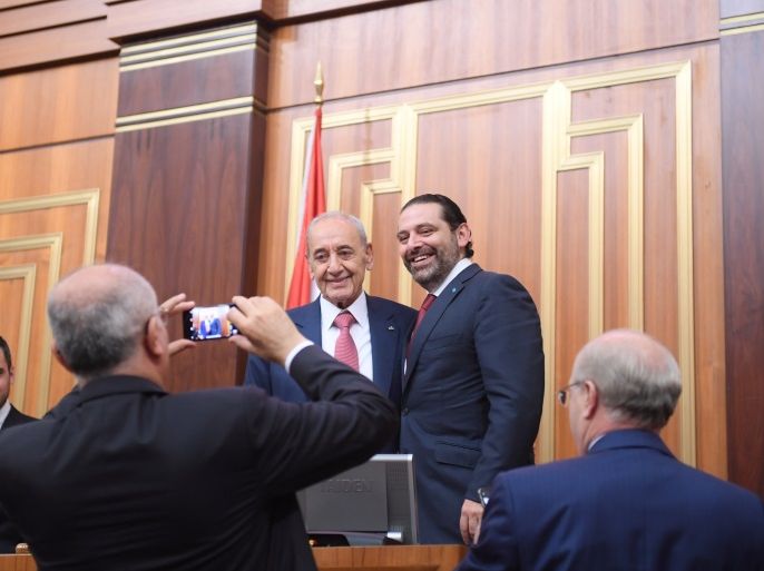 Lebanon's Finance Minister Ali Hassan Khalil takes photos of the parliamentary re-elected speaker Nabih Berri with outgoing Prime Minister Saad al-Hariri at the parliament in Beirut, Lebanon May 23, 2018. Lebanese Parliament/Handout via REUTERS ATTENTION EDITORS - THIS IMAGE WAS PROVIDED BY A THIRD PARTY