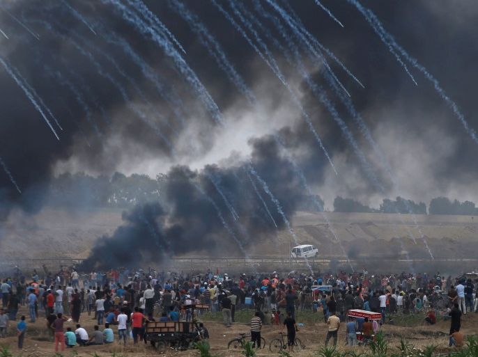 Tear gas canisters are fired by Israeli forces at Palestinian demonstrators during a protest demanding the right to return to their homeland, at the Israel-Gaza border, east of Gaza City, May 4, 2018. REUTERS/Mohammed Salem