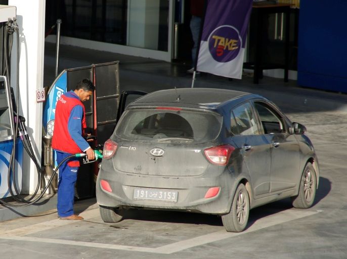 A gas station attendant pumps fuel into a customer's car at a gas station in Tunis, Tunisia November 24, 2017. REUTERS/Zoubeir Souissi