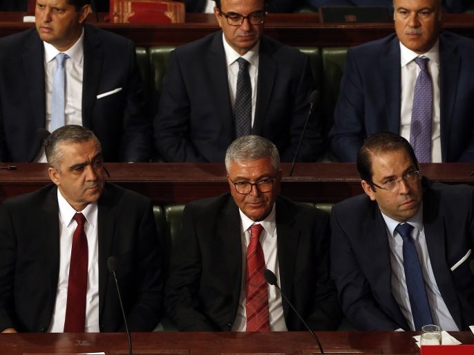 epa06198129 Tunisian Prime Minister Youssef Chahed (bottom, R) sits next to nominated Defense Minister, Abdelkrim Zbidi (bottom 2-R), nominated Interior Minister, Lotfi Brahem (bottom L) during a Parliament plenary session to vote confidence on the new cabinet, in Tunis, Tunisia, 11 September 2017. Tunisian Prime Minister Youssef Chahed on 06 September announced a cabinet reshuffle involving 13 ministries and 7 state secretariats. EPA-EFE/MOHAMED MESSARA