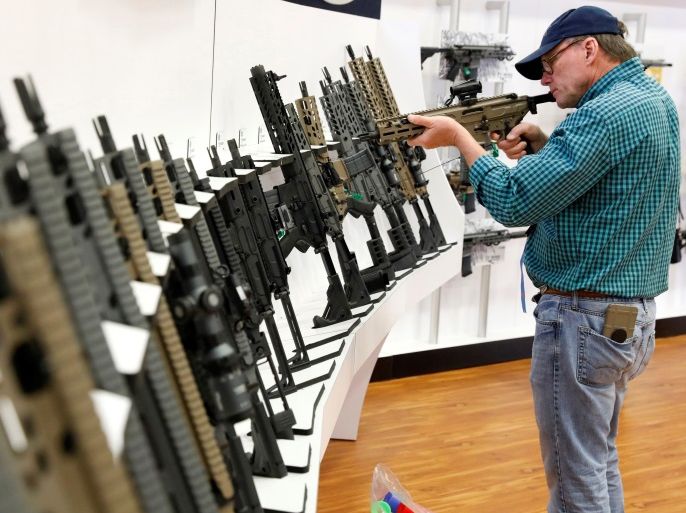 A gun enthusiast inspects a Sig Sauer rifle during the annual National Rifle Association (NRA) convention in Dallas, Texas, U.S., May 5, 2018. REUTERS/Lucas Jackson