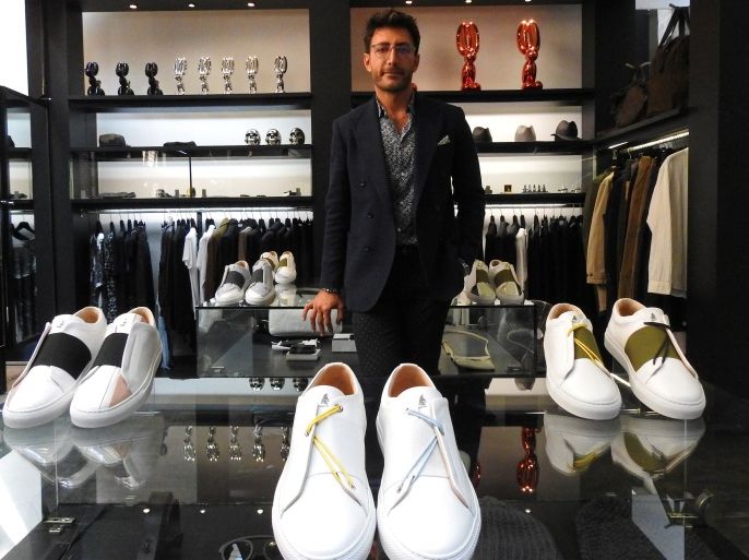 Syrian designer Daniel Essa poses with his prototype luxury sneakers displayed to be seen for online sale at a concept store in Lille, France, June 6, 2018. Picture taken June 6, 2018. REUTERS/Noemie Olive