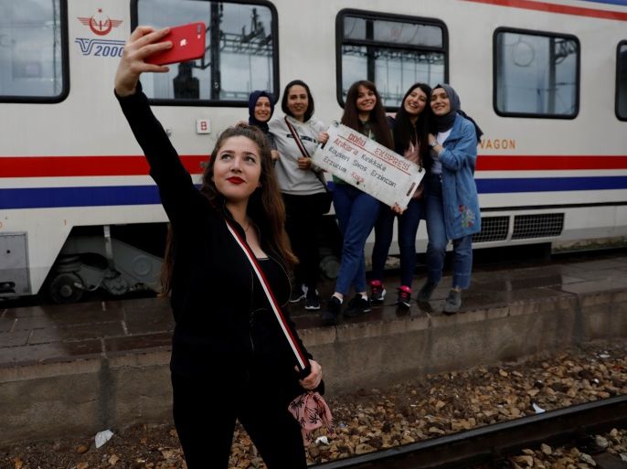 Sibel Uysal, 20, poses for a selfie with her friends before the Eastern Express departs from Ankara province en route from Ankara to Kars, Turkey, April 9, 2018. REUTERS/Umit Bektas SEARCH