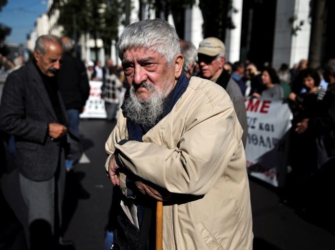 A Greek pensioner leans on a shepherd's crook during a demonstration against planned pension cuts in Athens, Greece, November 3, 2016. REUTERS/Alkis Konstantinidis