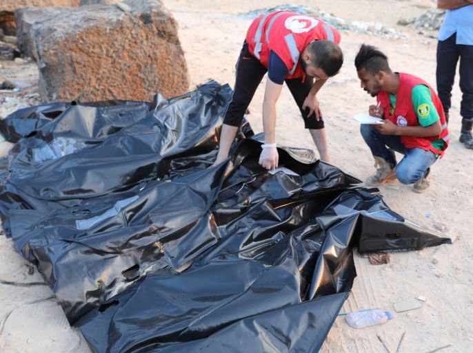 ATTENTION EDITORS - VISUAL COVERAGE OF SCENES OF INJURY OR DEATH Rescuers check covered dead bodies of migrants on the coast of Almayuh, west of Tripoli, Libya June 19, 2018. REUTERS/Hani Amara TEMPLATE OUT