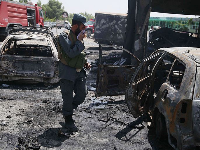 epa06877234 Afghan security officials inspect the scene of a suicide bomb attack that targeted National Directorate of Security (NDS) soldiers in Jalalabad, Afghanistan, 10 July 2018. At least 10 people including 2 NDS soldiers were killed and 4 others were injured in the incident. EPA-EFE/GHULAMULLAH HABIBI