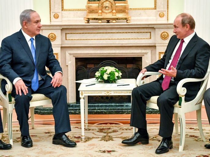 Russian President Vladimir Putin speaks with Israeli Prime Minister Benjamin Netanyahu during their meeting at the Kremlin in Moscow, Russia July 11, 2018. Yuri Kadobnov/Pool via REUTERS