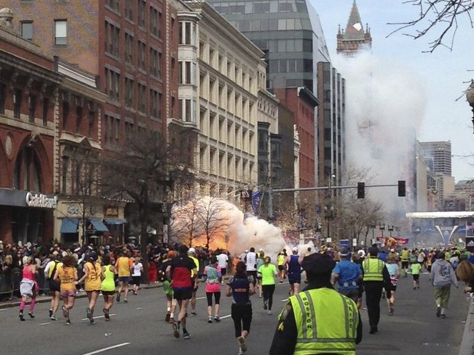 Runners continue to run towards the finish line of the Boston Marathon as an explosion erupts near the finish line of the race in this photo exclusively licensed to Reuters by photographer Dan Lampariello after he took the photo in Boston, Massachusetts, April 15, 2013. REUTERS/Dan Lampariello/File Photo MANDATORY CREDIT